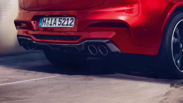M スポーツ・エキゾースト・システム。F98 トロント・レッド・メタリックのBMW X4 M コンペティション、エクステリア、M スポーツ・エキゾースト・システムとカーボン製ディフューザーの見えるリヤ・ビュー。F98