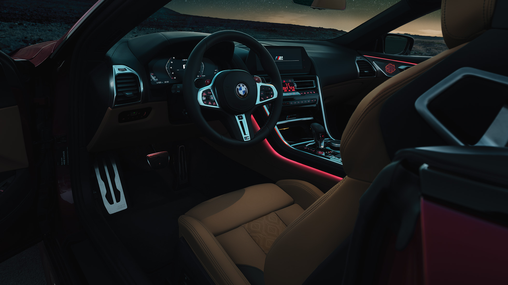 BMW M8 Competition カブリオレ、コックピット F91 BMW M8 Competition カブリオレ、M レザー・ステアリング・ハンドルと赤のアンビエントライトを備えた夜間のコックピット。F91