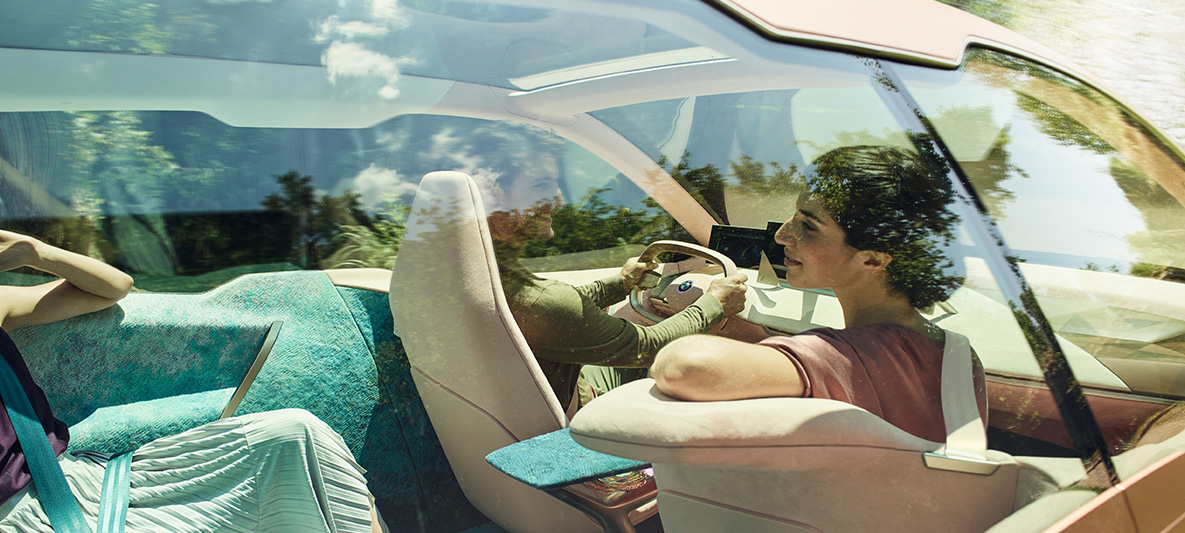 BMW Vision iNEXTの助手席に座る女性 BMW Vision iNEXTの助手席に座る黒髪の女性が後部座席を振り返っている画像