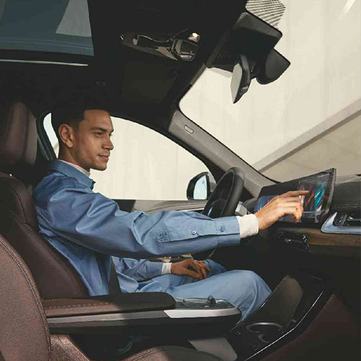 BMW 搭載のコネクテッド・チャージング BMW カーブド・ディスプレイを操作する男性 BMW 搭載のコネクテッド・チャージング BMW カーブド・ディスプレイを操作する男性