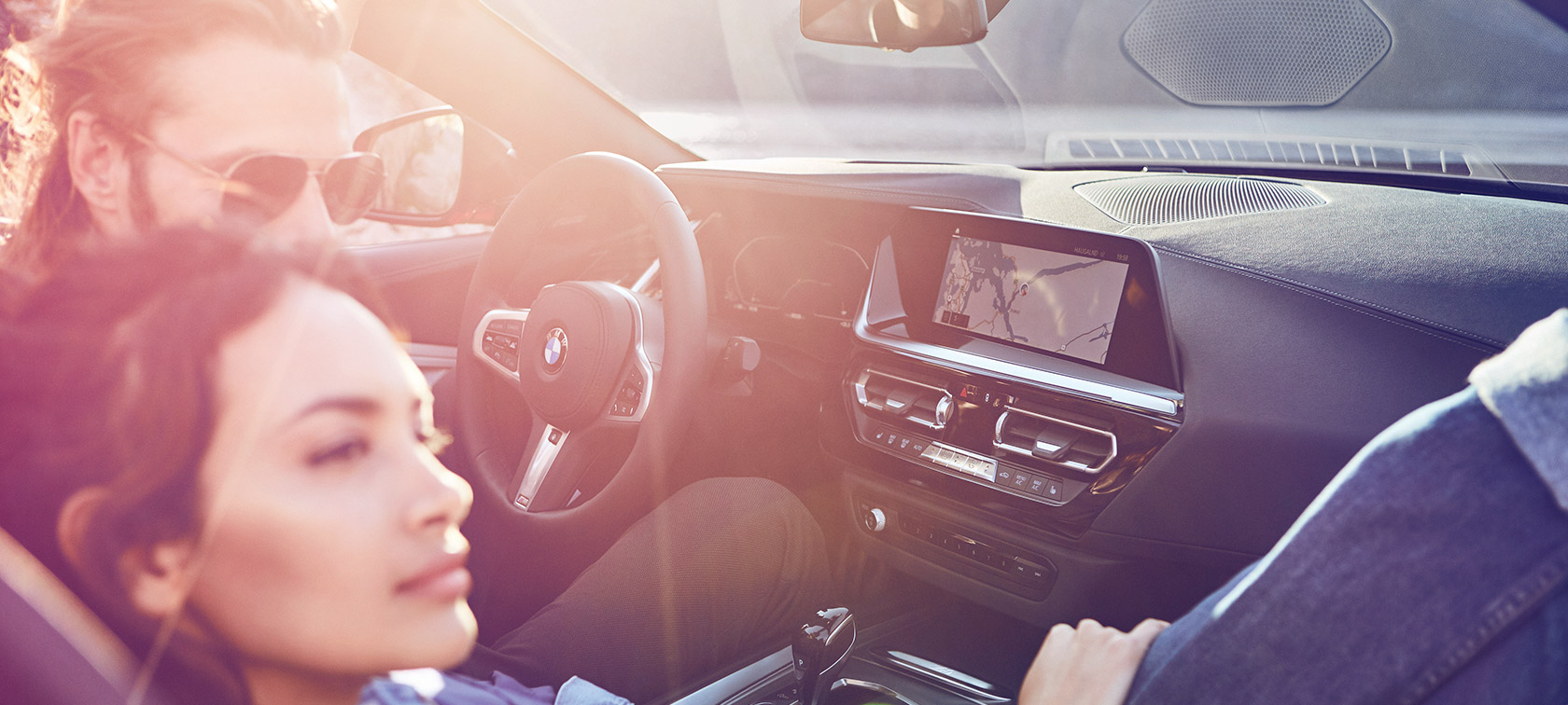 Woman and man sitting in BMW BMW Financial Services woman and man sitting in BMW